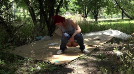 Nasty redhead Sara takes a piss on a homeless person's cardboard flooring 11827626