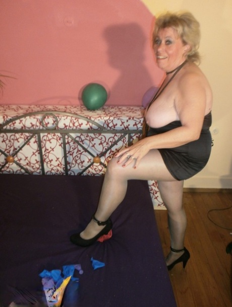 Old woman Caro bares her tits in pantyhose amid balloons on her bed 56533626