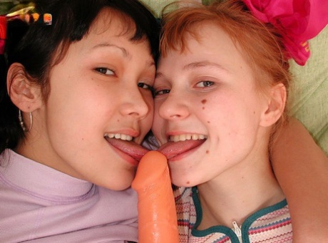 Young looking girls share a double ended dildo during interracial lesbian sex 52961866